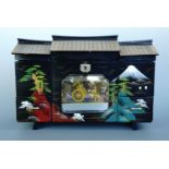 A 1950s kitsch Japanese black lacquered musical jewellery box, incorporating an animated and