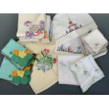 A quantity of hand-embroidered colourful tea linens, including napkins and tea table cloths