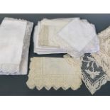 Antique and vintage whitework tea linens, including a damask cloths woven to depict Irish clover,