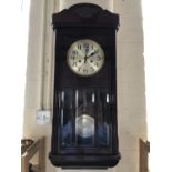 A 1920s - 1930s mahogany cased wall clock, with silvered dial and Arabic numerals, 78 cm