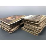 A quantity of un-mounted largely late 19th / early 20th Century postcards etc