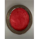 A Victorian Gothic influenced oval wooden picture frame, decorated with carved tracery, 46 x 40 cm
