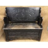 A George V carved oak monk's bench, 103 cm wide