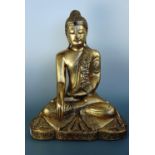 A large South East Asian carved and gilt wooden seated Buddha, 60 cm high