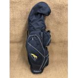 A Powakaddy golf bag together with Pinseeker irons and other clubs