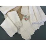 A quantity of fine Victorian whitework tea table cloths trimmed with crocheted lace, including a