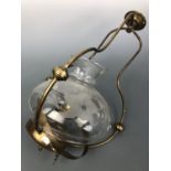 An antique pendant brass oil lamp with wheel-cut and etched glass shade, late 19th / early 20th