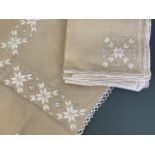 A late Victorian embroidered linen tea table cloth and eight napkins, the design incorporating