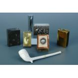 A collection of smoking related items comprising vintage lighters and vesta cases