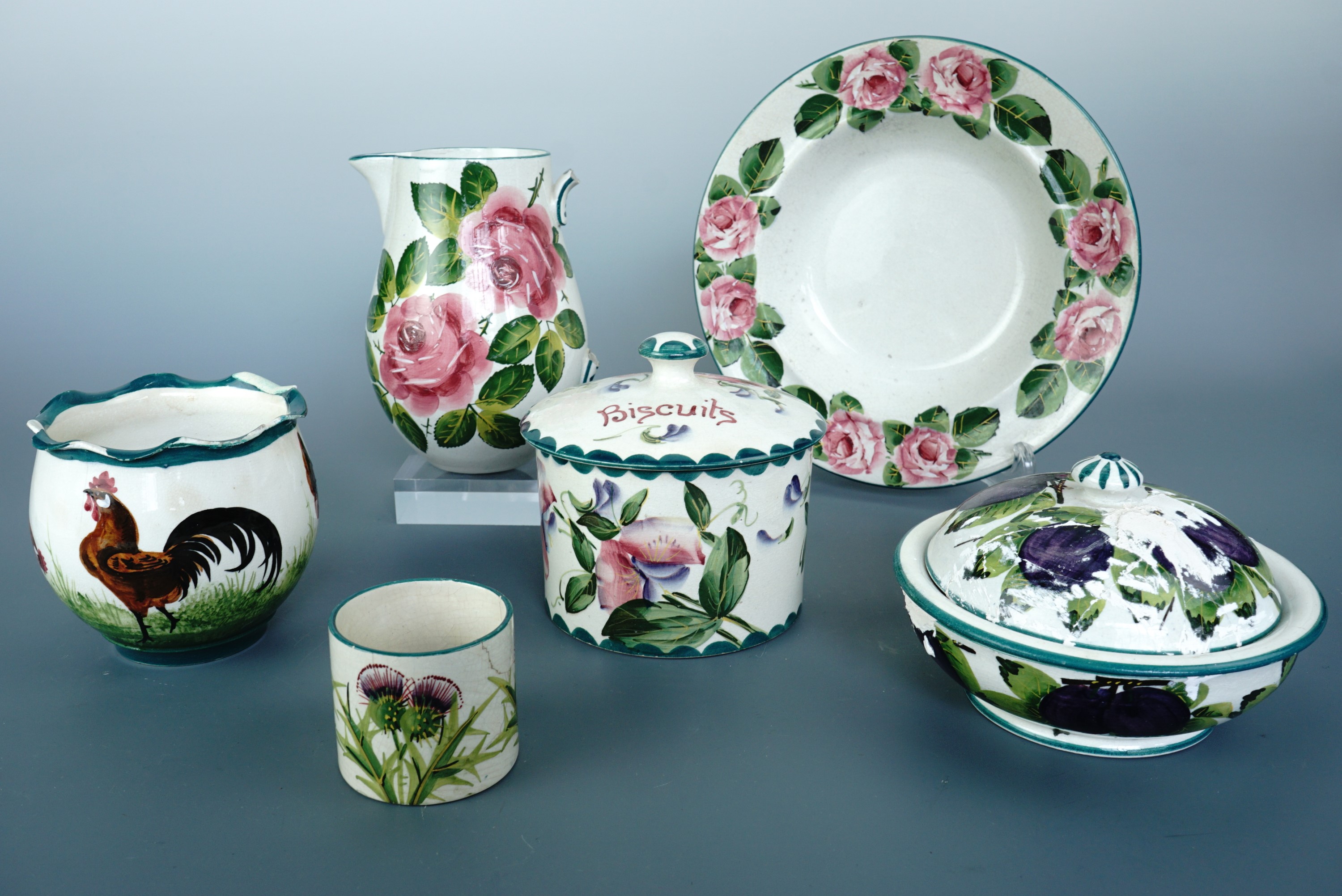 A collection of Wemyss Ware, including a pot decorated with cockerel, a shallow bowl decorated