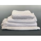 Four antique white woven coverlets, each in a geometric design