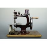 An Essex Miniature Sewing Machine, hand-driven, in original transport case with instruction booklet,