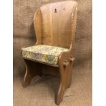 A mid-to-late 20th Century artisan-made carved oak lambing style chair, 120 cm high