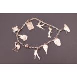 A vintage white metal charm bracelet, many of the charms being military and including a tank,