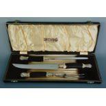 A cased George Butler and Co horn handled carving set