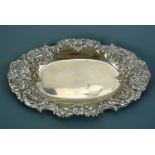 A late Victorian silver oval dish, having a Rococo influenced floral and foliate scroll decorated