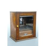 An early 20th Century glazed-oak smoker's cabinet, 26 x 18 x 30 cm high