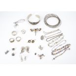 A collection of artisan white metal jewellery, including torque and other bangles, a dragonfly