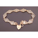 A two-colour 9ct gold brick-link bracelet, with heart-shaped padlock clasp, approximately 18 cm, 5.3