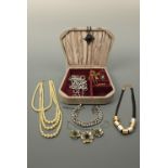 A vintage jewellery box containing a quantity of costume jewellery, including a 1960s cruciform