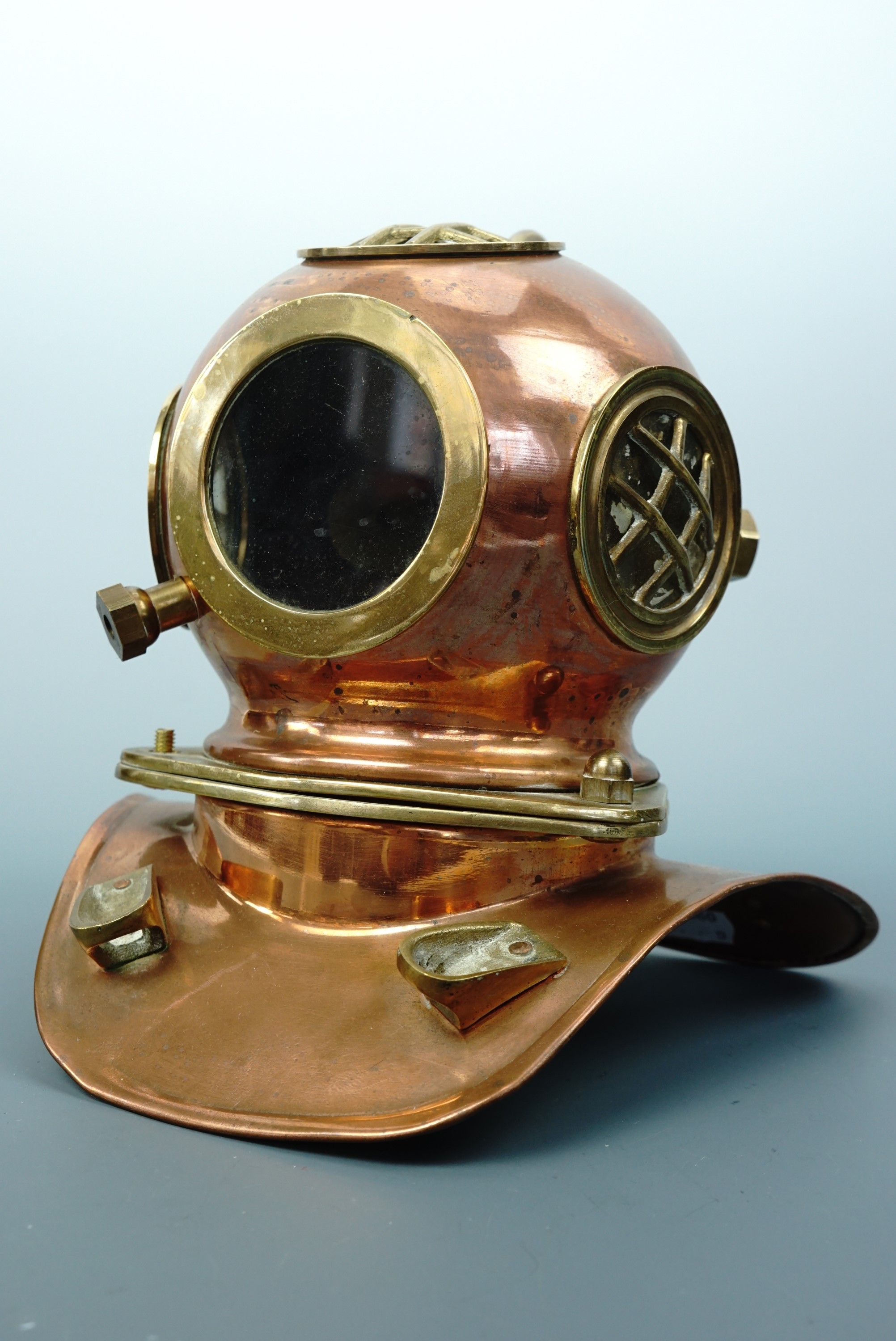 A miniature brass diver's helmet, 20 cm high