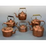Six copper kettles, the tallest 26 cm