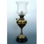 A Victorian brass and black ceramic oil lamp with later etched shade (converted)