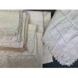 A quantity of Victorian tea table cloths, predominantly with lace trimmings, one having Art