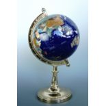 A contemporary terrestrial globe, countries denoted by inlaid polished mineral specimens, 43 cm