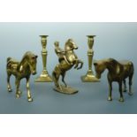 A pair of brass candlesticks, 20 cm high, together with two brass horse figures and rearing horse