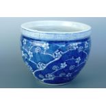 A 20th Century Chinese blue-and-white prunus pattern jardiniere, 21 cm high