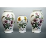 A pair of Portmeirion Lily Flowered Azalea vases, 25 cm high, together with an African Daisy vase,