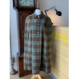A vintage reversible tartan cape, lined with green cotton