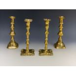 A pair of old reproduction mid 18th Century brass candlesticks together with a pair of Victorian