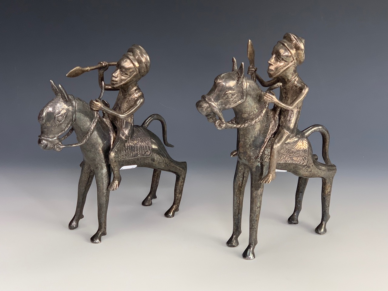 Two Benin style electroplate figures of mounted tribal horsemen, 23 cm