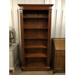 A contemporary tall mahogany open-fronted bookcase, having adjustable wooden shelves, 97 cm x 35