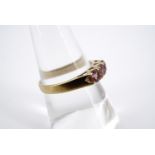 A contemporary 9ct gold and pink tourmaline dress ring, having three round-cut stones of a total .