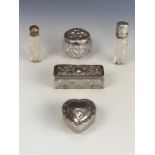 Four late 19th / early 20th Century silver-lidded cut glass dressing table boxes including a heart-