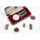 A cased Women's Voluntary Service medal and sundry items of insignia