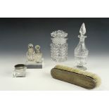 A Victorian cut glass cruet together with silver-collared and other perfume bottles, toiletry
