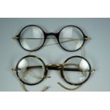 A set of early 20th Century faux-tortoiseshell framed spectacles and one other similar set