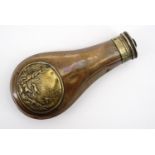 A Victorian Sykes' patent powder flask, faced with an embossed brass plaque depicting a hunting