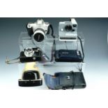 A Kodak, Canon EOS 300, Polaroid "The Button" and Halina Simplette FC cameras
