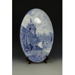 An early 20th Century blue and white oval plaque depicting an 18th Century scene at the Zwinger