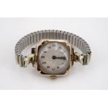 A 1920s lady's 9ct gold wristlet watch, having a rose engine turned silvered face with blued steel