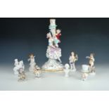 A Meissen figural candle stick together with other small figures, former 32 cm.