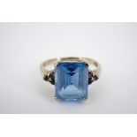 A contemporary 9ct gold and "Swiss" blue Topaz and tanzanite cocktail ring, having a central