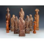 A group of carved Chinese Immortals etc, tallest 41 cm