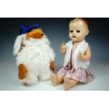 A vintage plush Womble school boy, 30 cm, together with a 1950s Pedigree "walking talking" baby