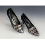 A 1980s pair of Mary Quant court shoes, in navy blue with a metallic diaper pattern toe,